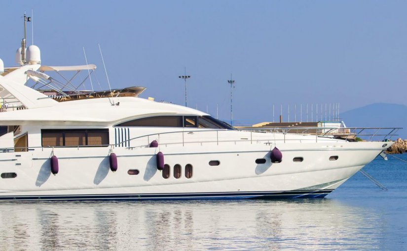 Luxury yacht docked in calm waters, showcasing sleek design and marine features, relevant to yacht electronics and comfort.