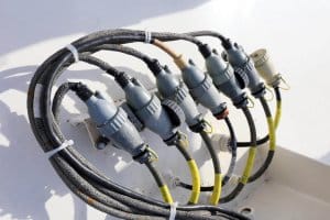 Marine electrical connectors and cables on a yacht, illustrating essential marine electrical supplies for boat owners.