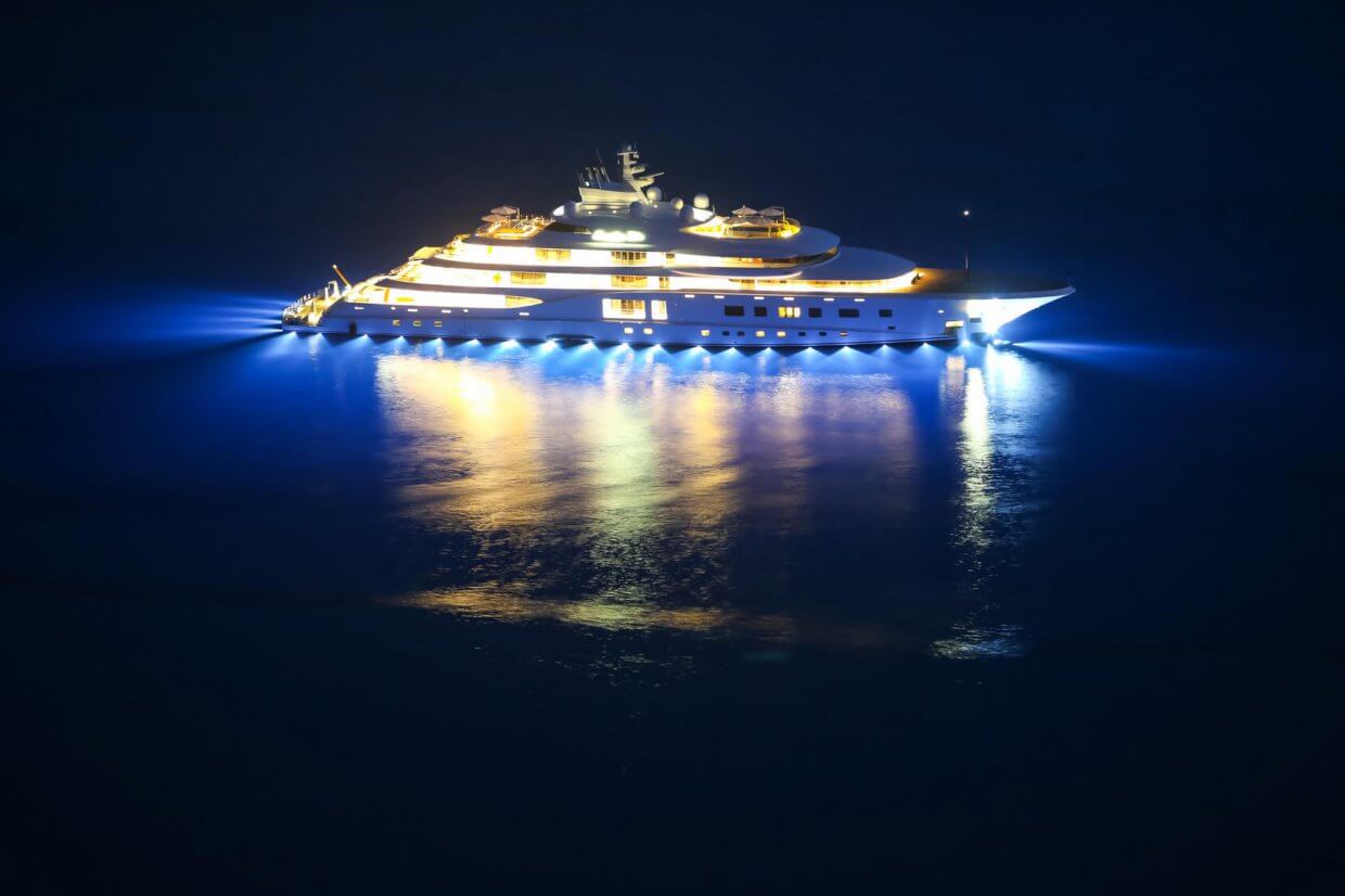 An illuminated luxury yacht in the Adriatiac sea at night in Dalmatia, Croatia. Luxury yacht illuminated with LED lights, showcasing marine lighting solutions and aesthetics in a nighttime setting.