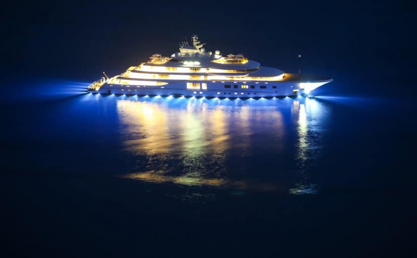 Luxury yacht illuminated at night with LED lighting, showcasing marine electrical solutions and advanced lighting technology.