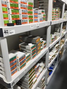 Shelves stocked with various Bticino electrical products, including switches and outlets, in a well-organized display for the TESS Blowout Sale.