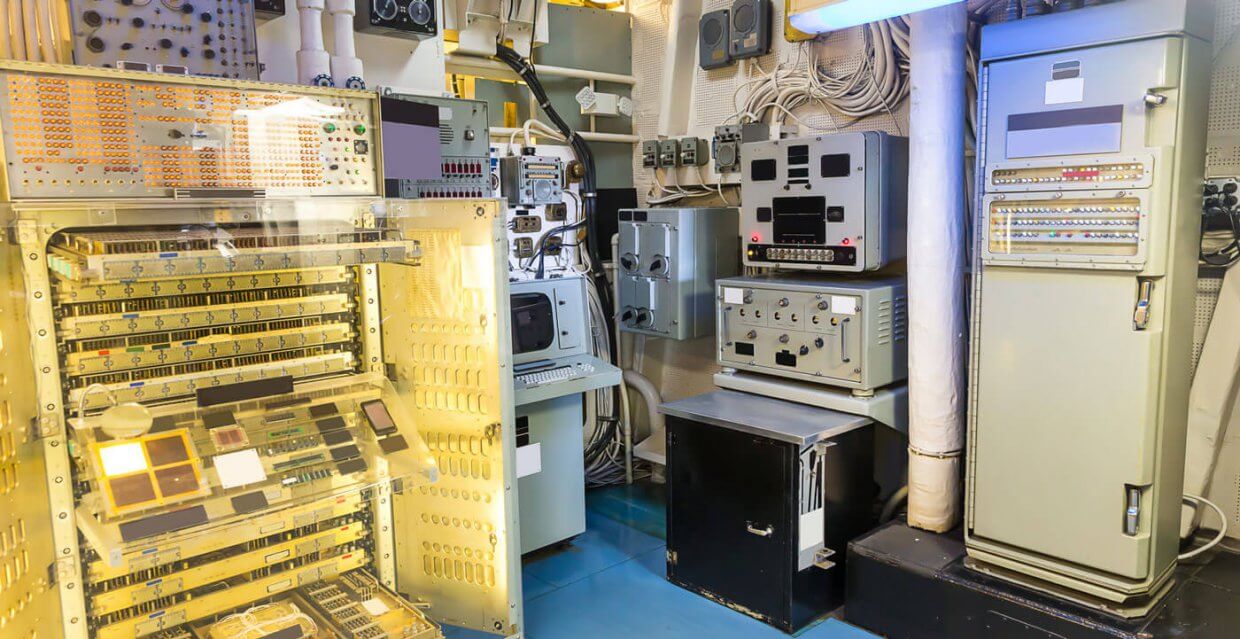 Control room with advanced automation equipment and monitoring systems for marine applications, showcasing TESS's expertise in alarm monitoring and power management solutions.