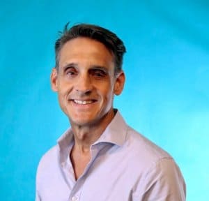 Brett Fitzgerald, new member of Tess Electrical LLC team, smiling against a blue background.