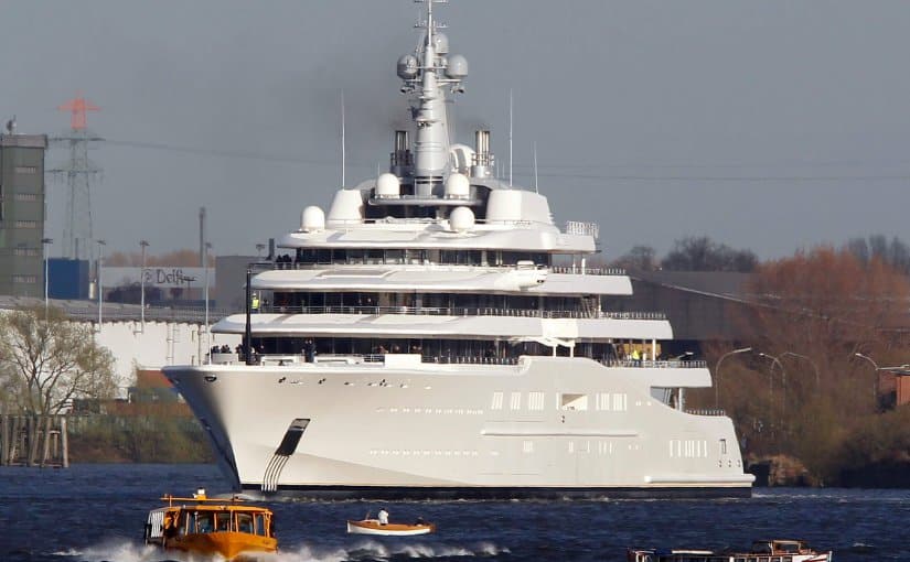 Eclipse yacht, a luxury mega-yacht, showcasing its sleek design and expansive structure on the water, surrounded by smaller boats, highlighting the opulence of high-end yachting.