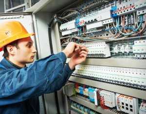 Electrician working on marine electrical panel installation, showcasing expertise in yacht services and automation.