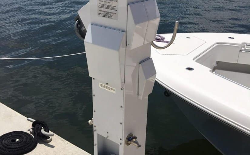 Electrical pedestal at Grove Isle Marina, Miami, with yacht in background, showcasing Tess Electrical LLC's marine services and ongoing 52 pedestal refit project.