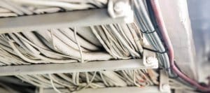 Marine electrical wiring and insulation under a yacht, showcasing organized cables and connections relevant to yacht electrical systems.