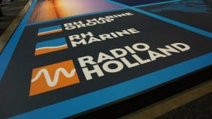 RH Marine and Radio Holland logos on a promotional display, highlighting marine electrical services and expertise in the maritime industry.