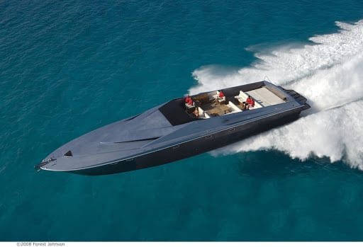 Luxury super yacht cruising at high speed on turquoise waters, showcasing sleek design and powerful performance, relevant to fast yachts in 2020.