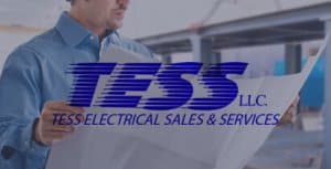 Man reviewing electrical plans with TESS Electrical Sales & Services logo, highlighting expertise in marine electrical solutions.