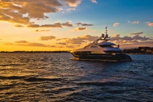 Luxury yacht sailing on water during sunset, showcasing marine lifestyle and electrical systems in yachting context.