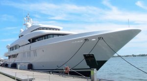 Luxury yacht docked at marina, showcasing sleek design and modern features, relevant to marine electrical services and yacht maintenance discussions.