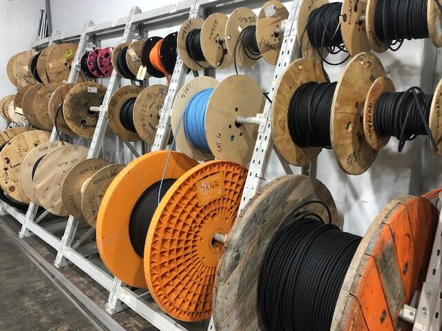 Cable spools in various colors and sizes, showcasing a range of electrical wires for marine engineering and installation projects.