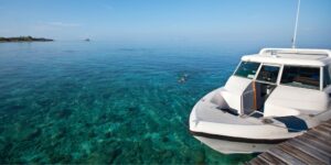 Luxury yacht anchored in clear blue waters, showcasing marine electrical services and maintenance in a tropical setting.