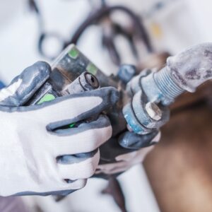 Technician's hands holding marine electrical component, showcasing expertise in yacht services and commitment to quality maintenance.