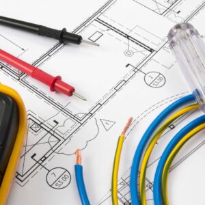 Electrical tools and wiring on marine blueprints, highlighting expertise in yacht electrical services, relevant to Tess LLC's commitment to quality and professionalism in South Florida.