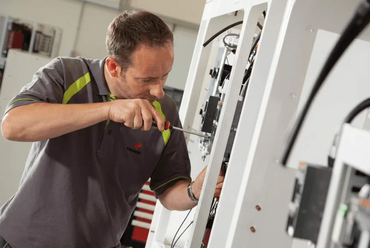 Technician working on Magnus frequency converter, ensuring reliable operation and maintenance in marine electrical systems.