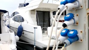 Yacht with shore power connections and electrical outlets, emphasizing marine electrical systems and maintenance for luxury vessels.