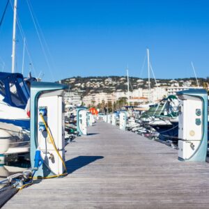 Marina dock with electrical charging stations for yachts, showcasing convenience and accessibility for marine electrical services.
