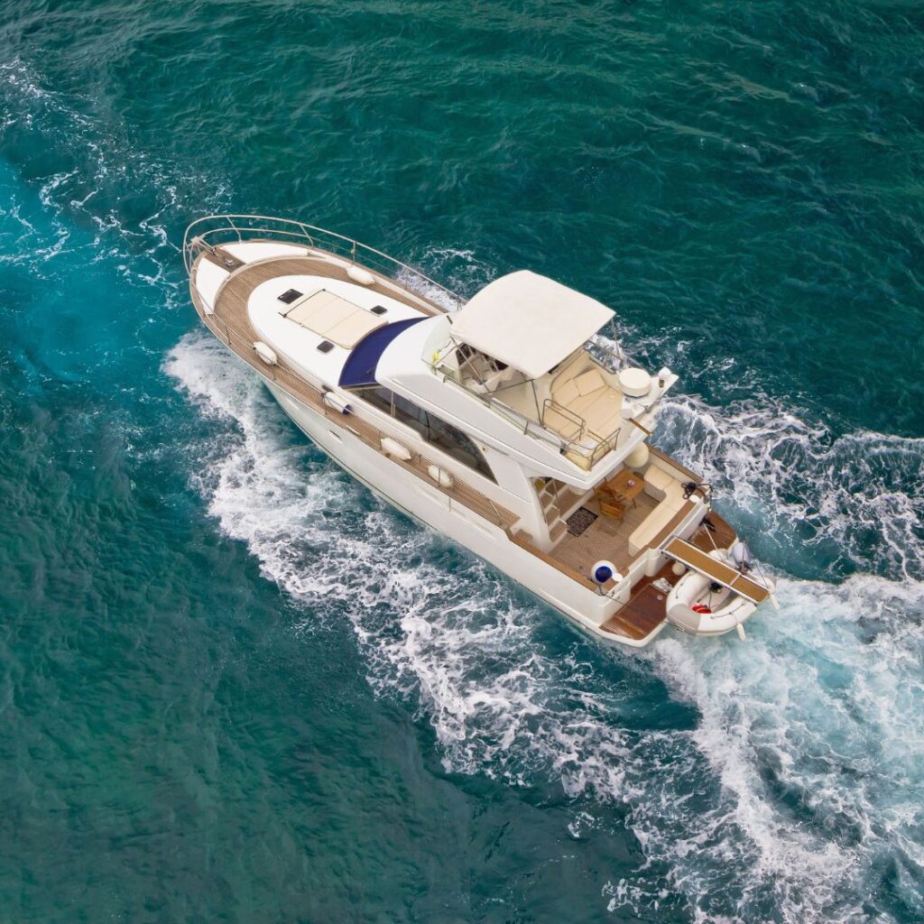 Luxury yacht navigating through turquoise waters, emphasizing the importance of yacht security and alarm systems for safety and peace of mind.