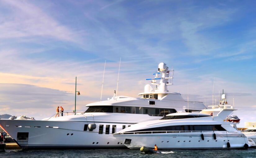 Luxury yachts docked at marina, showcasing advanced marine design and engineering, relevant to Tess LLC's marine power management services.