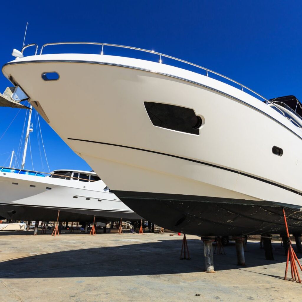 Luxury yacht on dry dock, showcasing hull maintenance and repair, emphasizing the importance of specialized equipment and quality service in marine repairs.