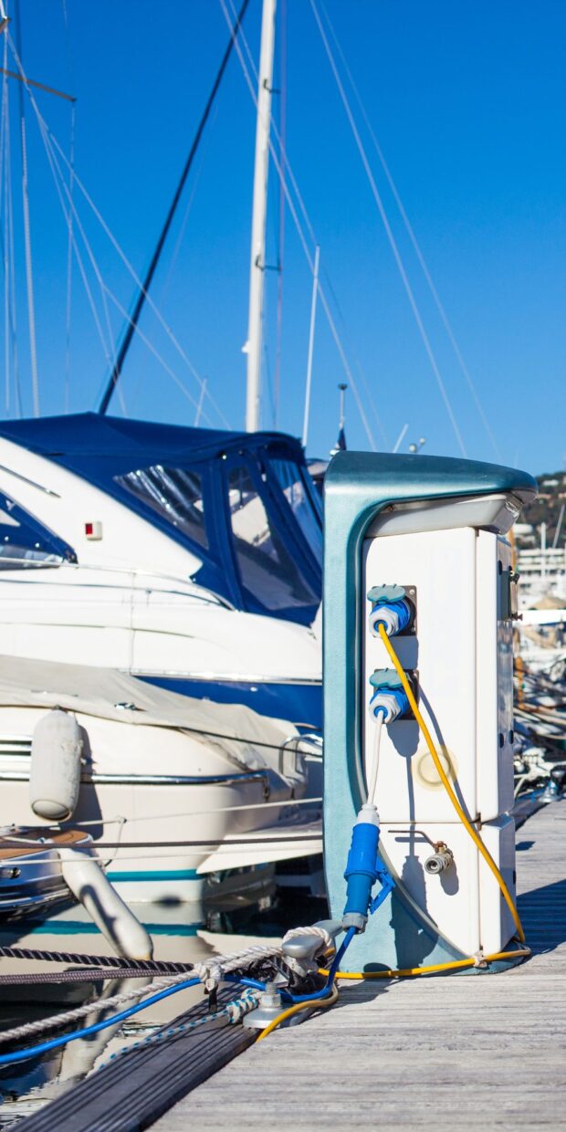 a dock of yachts with electrical charging stations