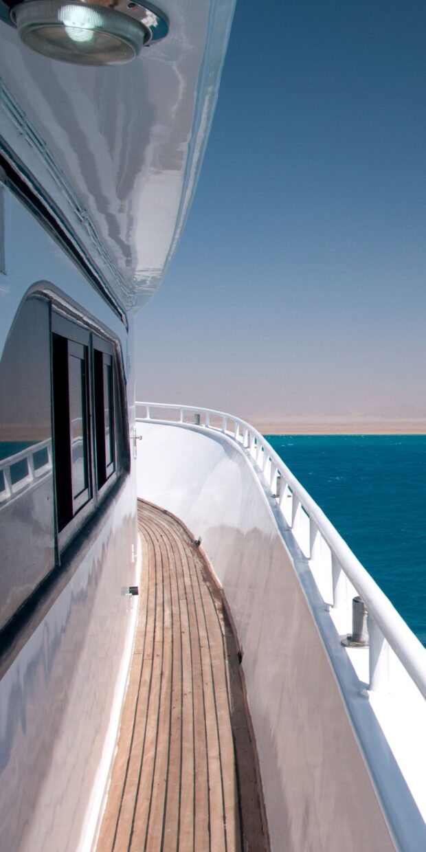 Yacht deck with polished railings and wooden walkway overlooking blue waters, symbolizing TESS Electrical LLC's marine electrical services in Dade County.