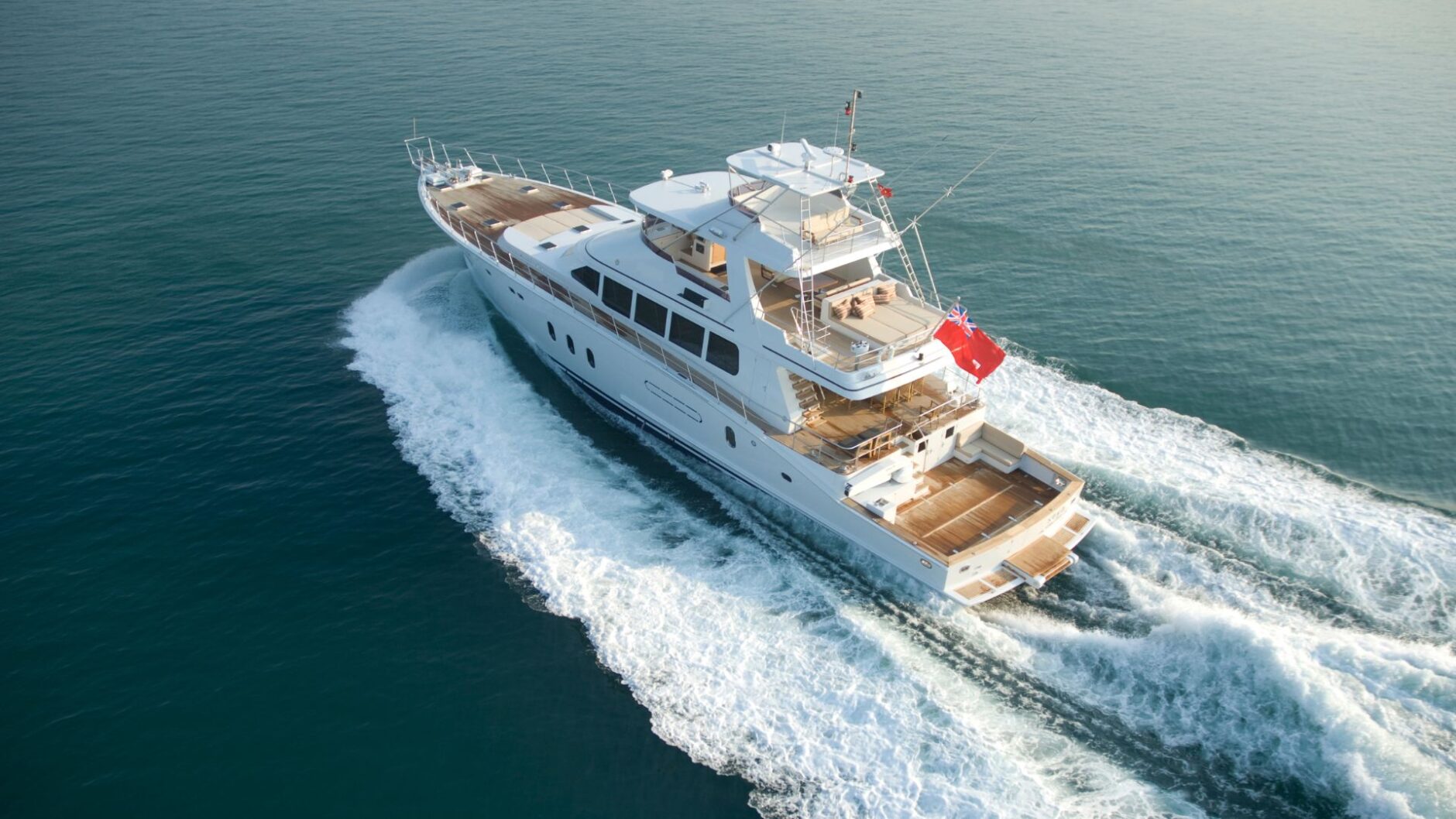 Luxury yacht cruising through calm waters, showcasing high-quality marine engineering and electrical services relevant to yacht maintenance in Dade County.