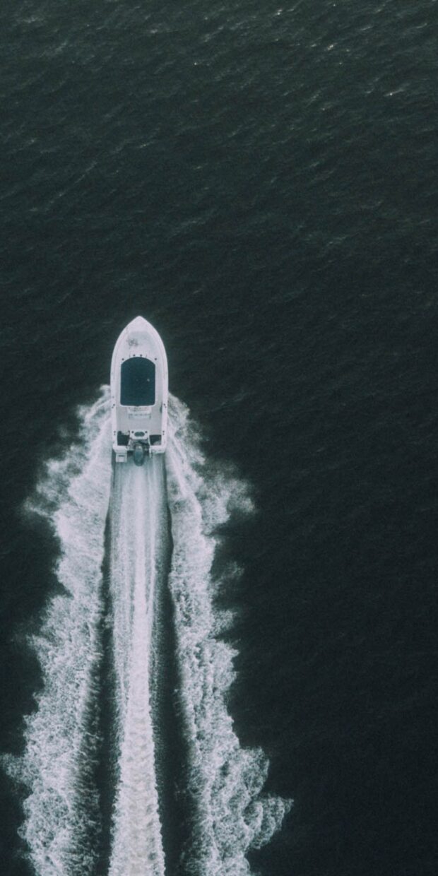 Yacht navigating through water, showcasing marine electrical services and vessel performance.