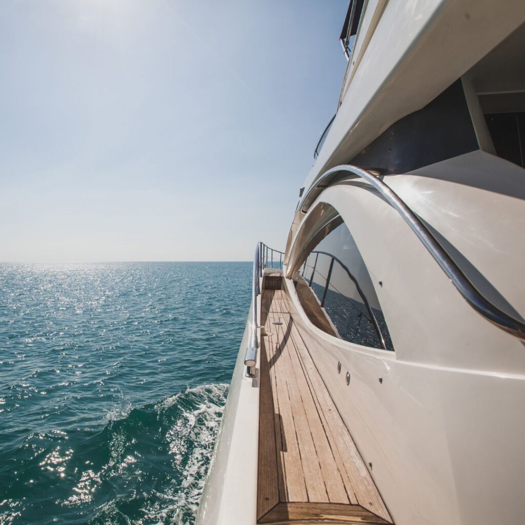 Luxury yacht cruising on calm waters, showcasing sleek design and polished surfaces, emphasizing marine electrical systems and security needs.