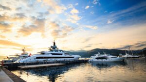 Yachts docked in a marina at sunset, highlighting the importance of yacht security and maintenance services offered by TESS LLC in Fort Lauderdale.