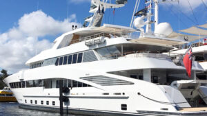 Luxury yacht docked in marina, showcasing modern design and power management features, relevant to marine electrical services and yacht efficiency.