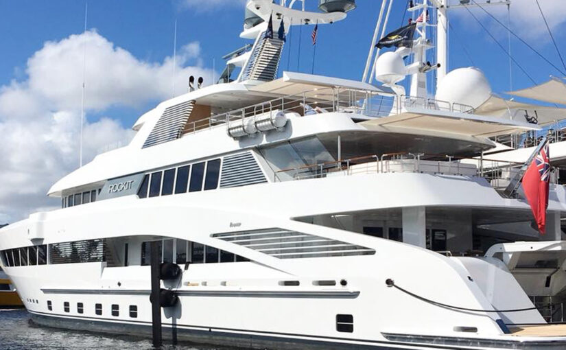 Luxury yacht docked with sleek design, emphasizing marine electrical systems and maintenance services relevant to yacht power efficiency.
