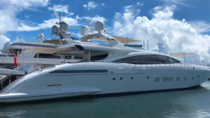 Luxury yacht docked in marina, showcasing sleek design and advanced marine technology, relevant to yacht power systems and shore power solutions discussed by TESS LLC.