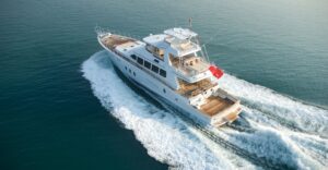 Luxury yacht cruising through calm waters, showcasing marine engineering and electrical service excellence by TESS LLC in Southern Florida.