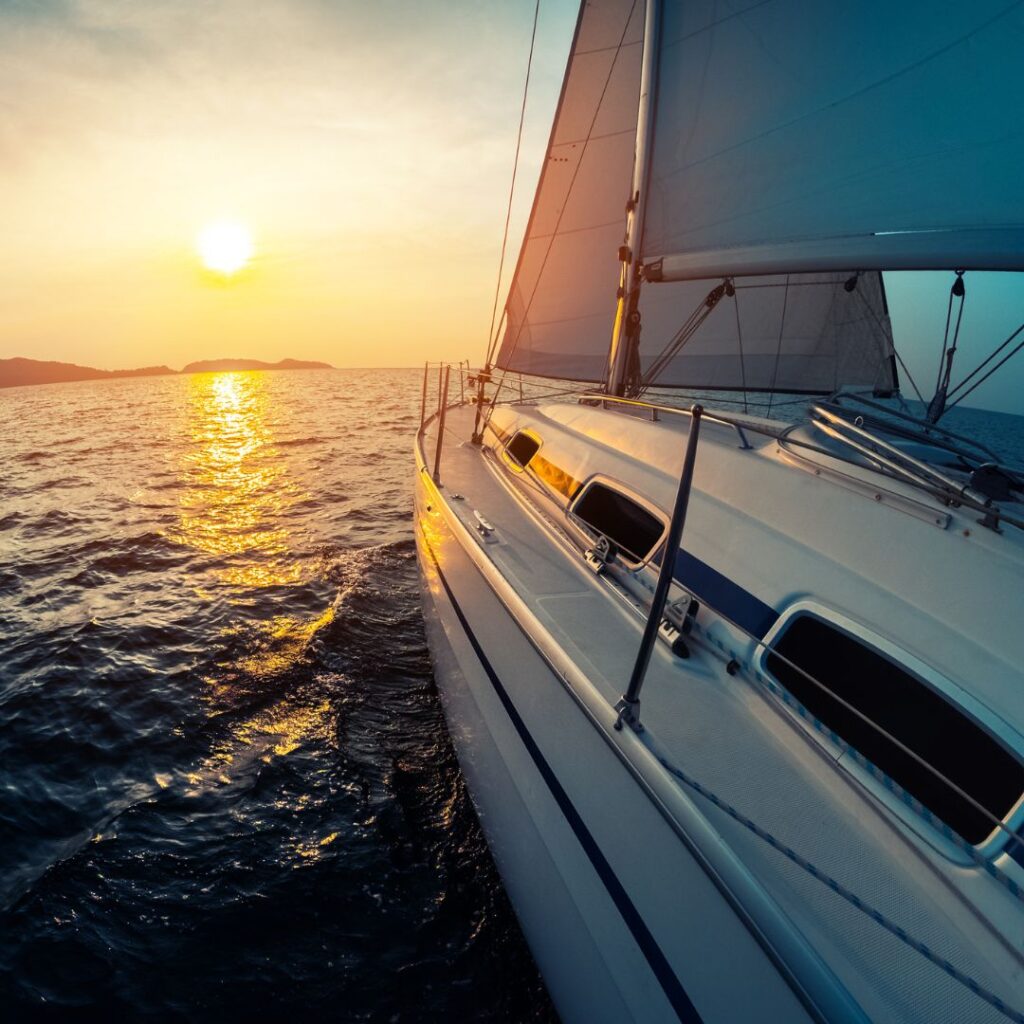 Luxury yacht sailing at sunset, reflecting the importance of yacht security amidst rising theft concerns in South Florida.