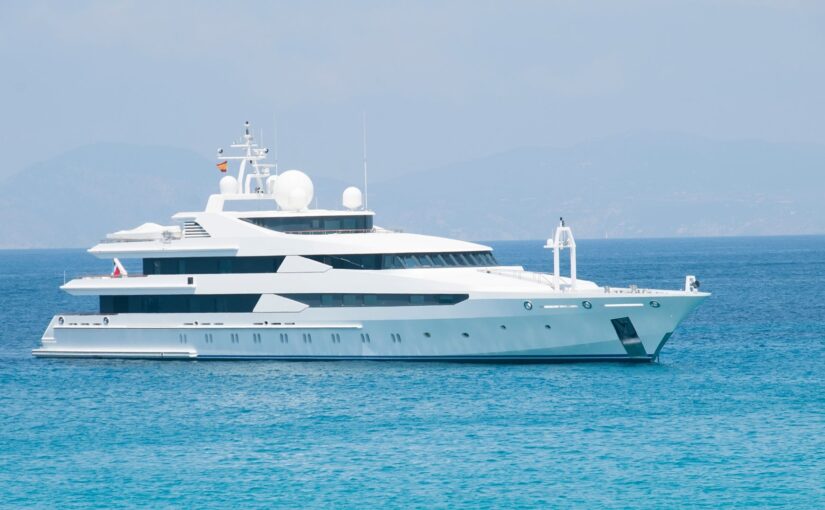 Luxury yacht anchored in calm waters, showcasing advanced marine electrical systems and design, relevant to maximizing yacht efficiency and TESS LLC's marine services.