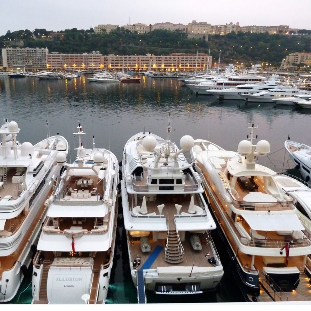 Yachts docked at a marina, showcasing various electrical systems and components, highlighting the importance of reliable shore power connections for yacht owners.
