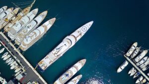 Aerial view of yachts docked in a marina, highlighting luxury vessels and the importance of marine electrical services for yacht operations.
