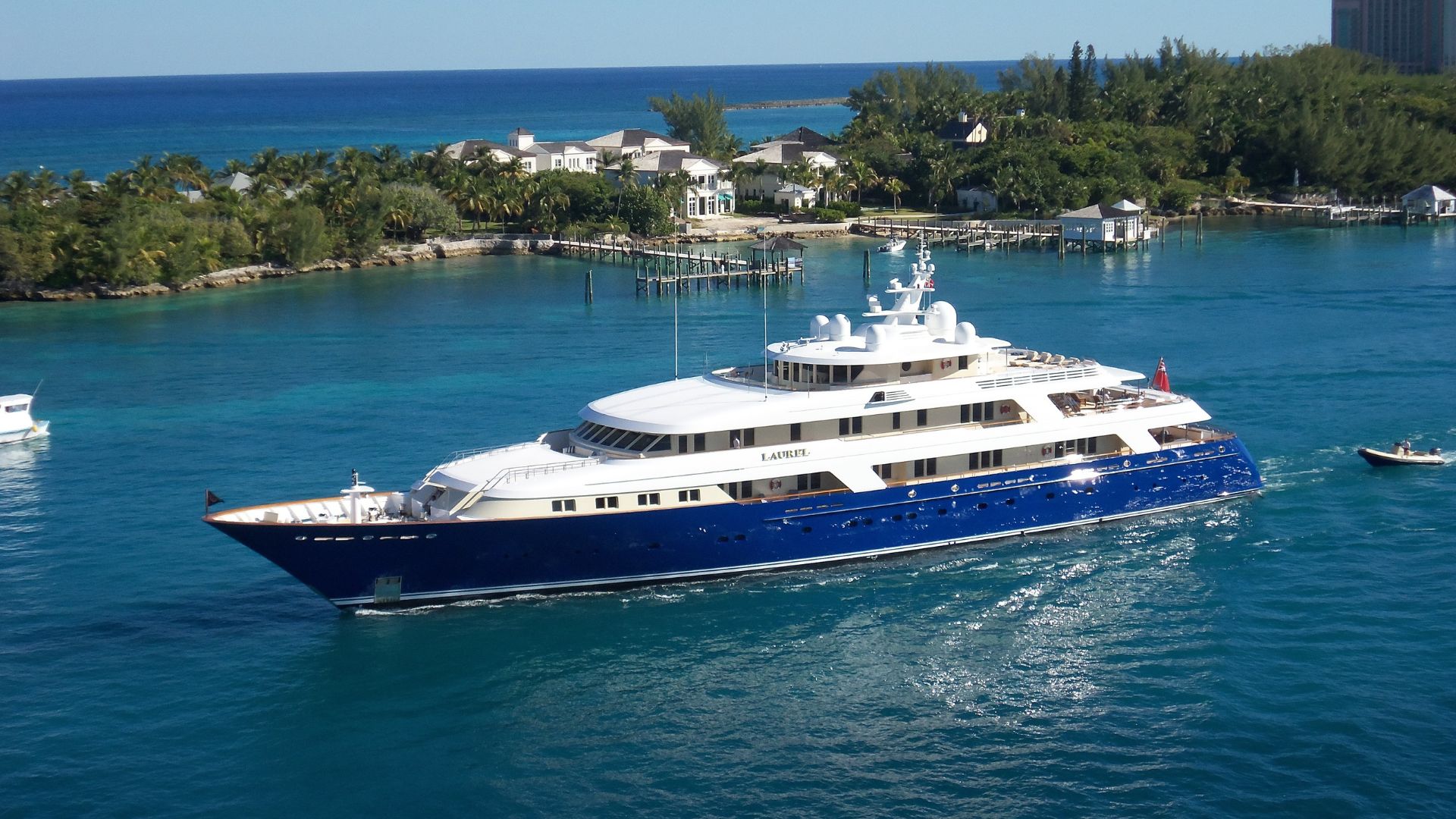 img cantalupi 02 Luxury yacht "Laurel" navigating clear blue waters near tropical shoreline, showcasing marine electrical systems relevant to TESS's offerings for yachts and commercial vessels.