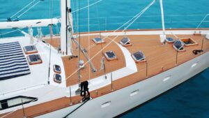 Sailboat deck with solar panels and a clear blue ocean background, highlighting marine electrical solutions in Savannah, GA.