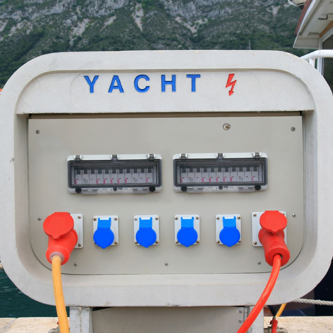Yacht electrical power management system with blue and red connectors, showcasing electrical upgrades for boat owners in Savannah.