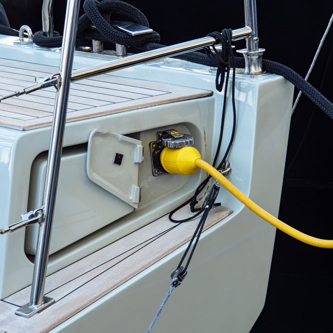 Yacht electrical power management system with yellow shore power cable connected, highlighting essential electrical upgrades for boat owners in Savannah.