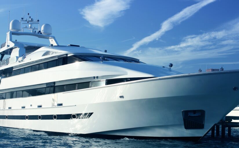 Luxury yacht in marina highlighting maritime safety and efficiency, relevant to Magnus Shore Converters and TESS Electrical LLC's services.