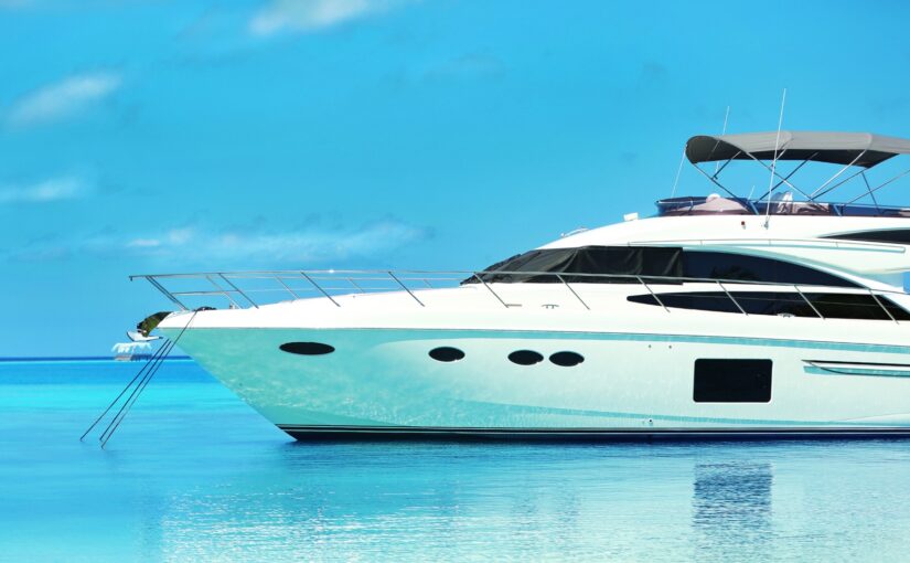 Luxury yacht anchored in calm blue waters, showcasing elegant design and marine efficiency, relevant to Magnus Shore Converters for vessel performance.