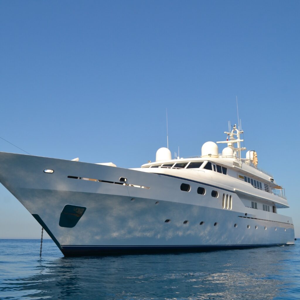 Luxury yacht in calm waters, showcasing marine electrical solutions and efficiency benefits related to Magnus Shore Converters.
