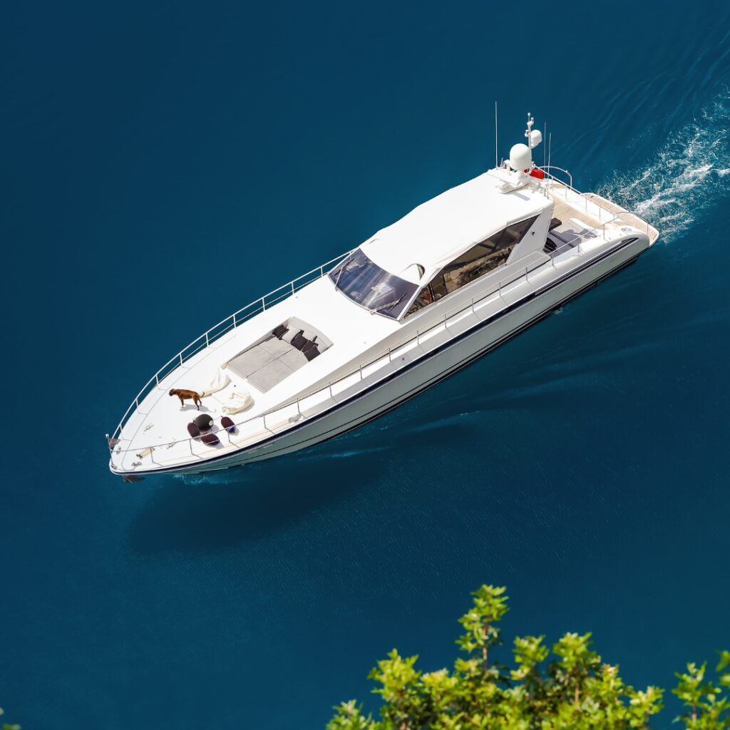 Luxury yacht cruising on clear blue waters, showcasing TESS Electrical LLC's yacht maintenance expertise and Safe Harbor Savannah Yacht Center's commitment to vessel performance.