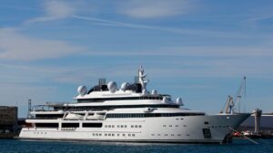 Luxury superyacht docked in harbor showcasing advanced marine technology and design, relevant to TESS Electrical's marine electrical services for yachts.