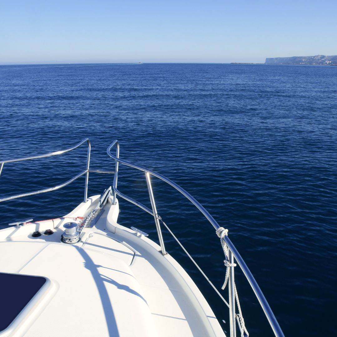 Yacht bow with polished railing overlooking calm Mediterranean waters in Barcelona, highlighting TESS, LLC's marine electrical services for modern yachts.